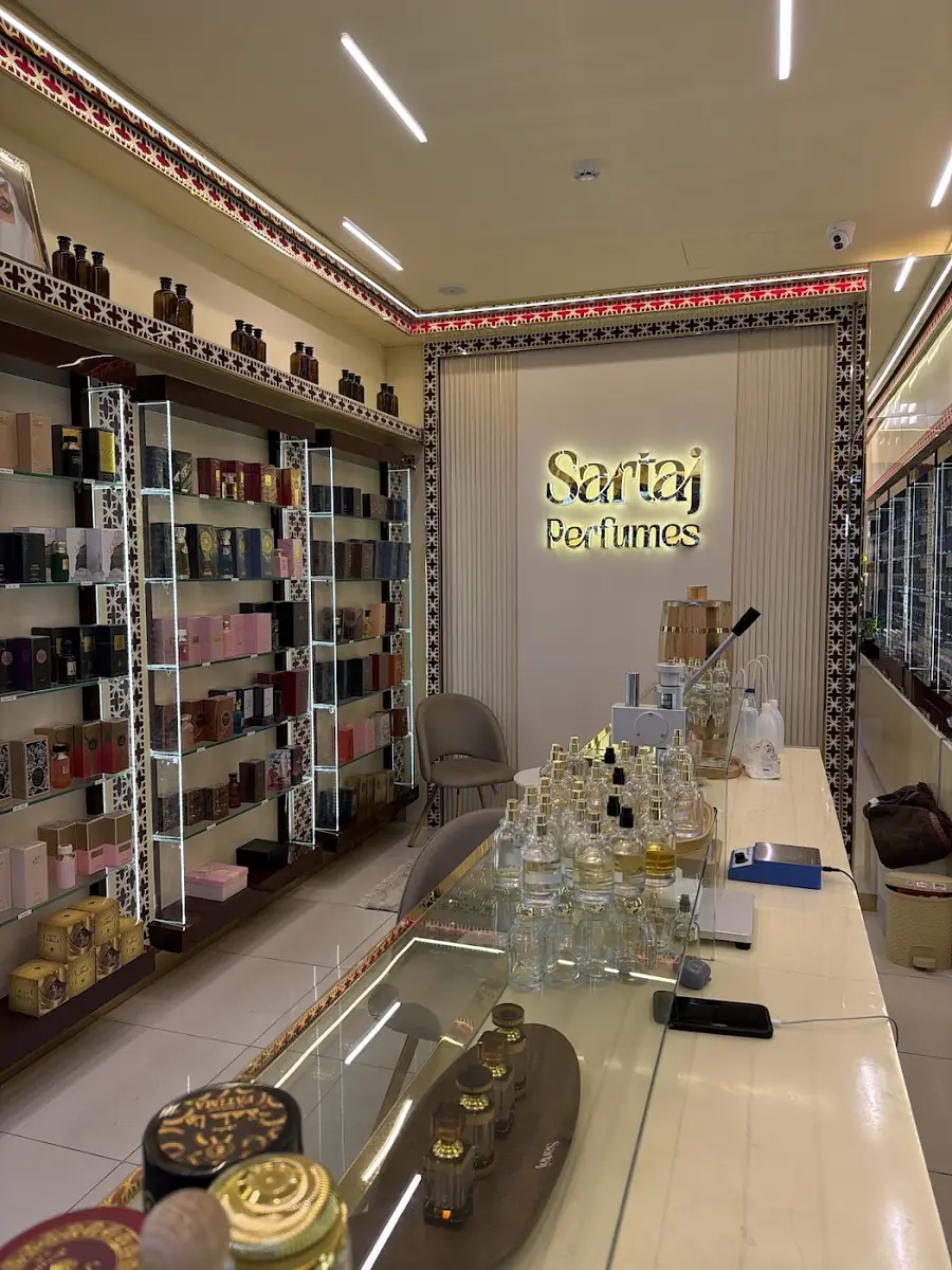 Inside Sartaj Perfumes: carved wooden shelves lined with perfume bottles